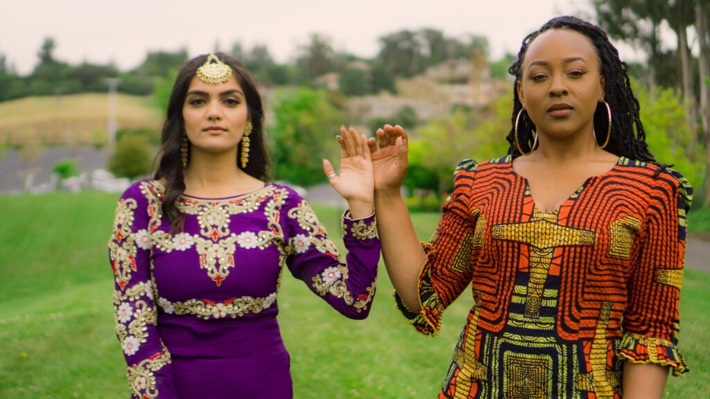 two women standing on field